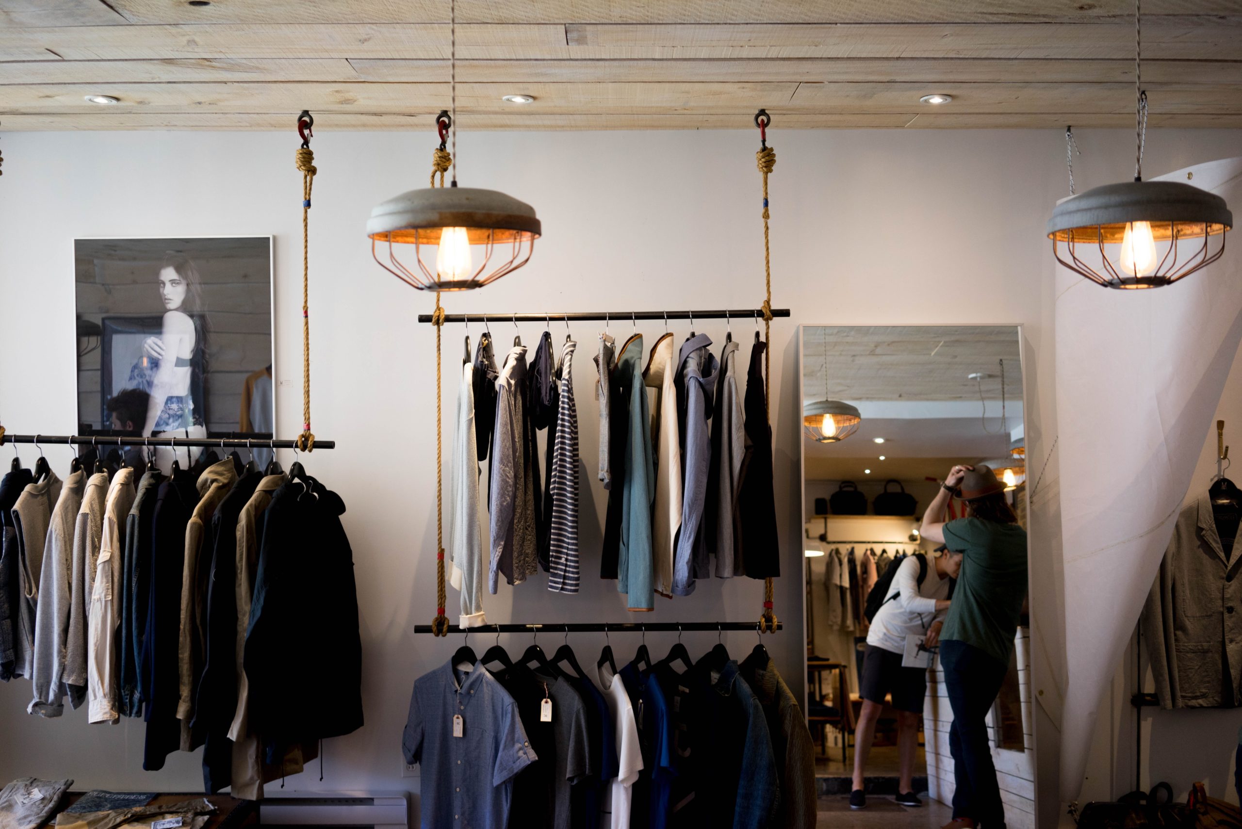 person leaning on wall in a retail store