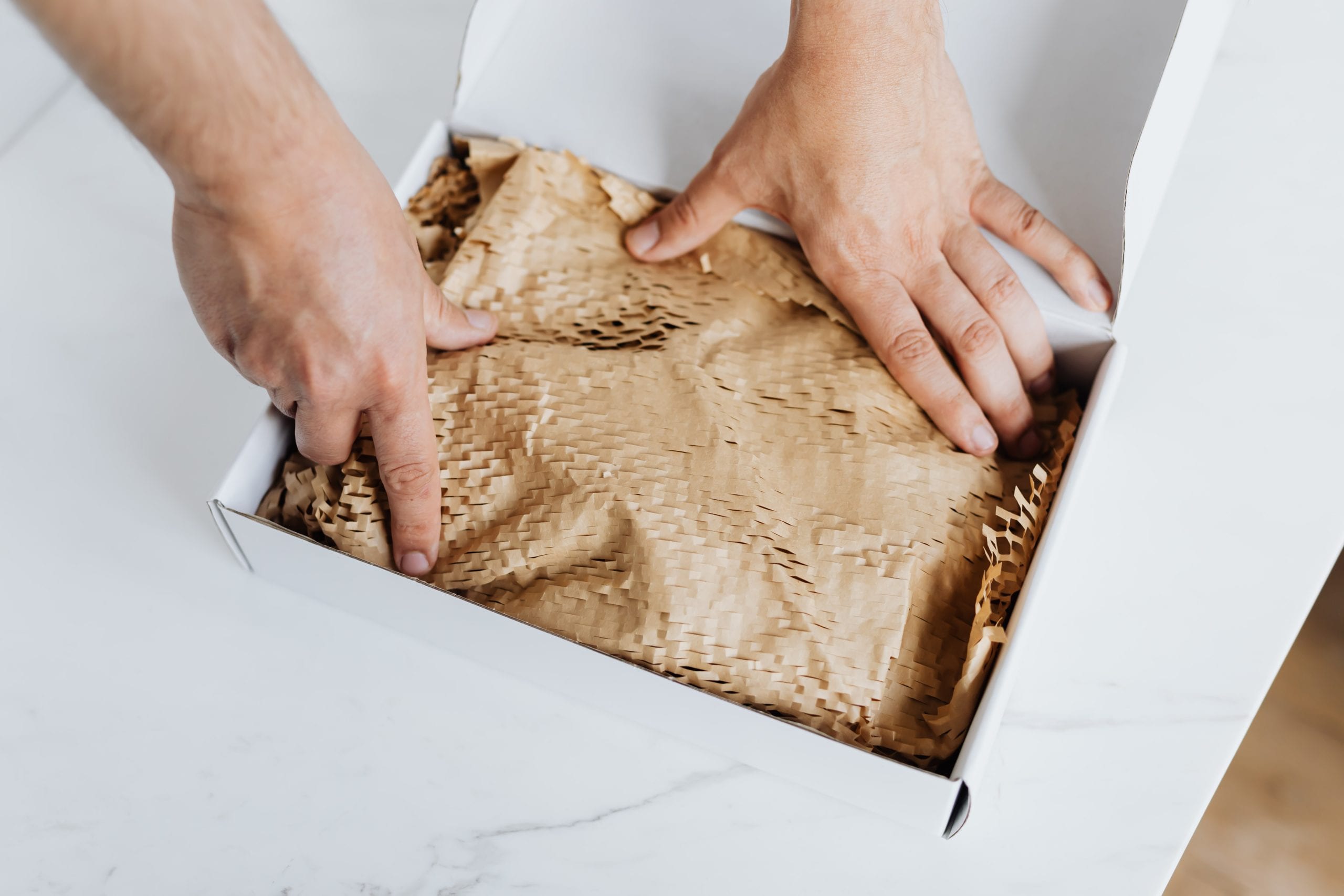 male hands opening a white box